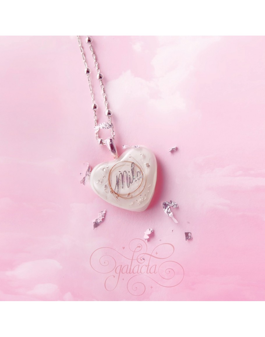 Heart shaped pendant with breast milk and a lock of baby's ...