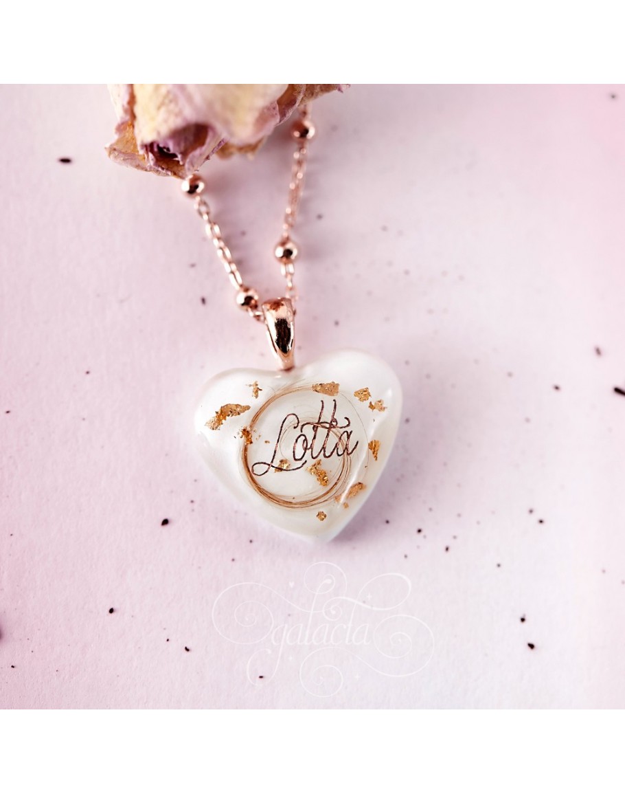 Heart shaped pendant with breast milk and a lock of baby's ...